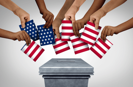 hands adding ballots to box